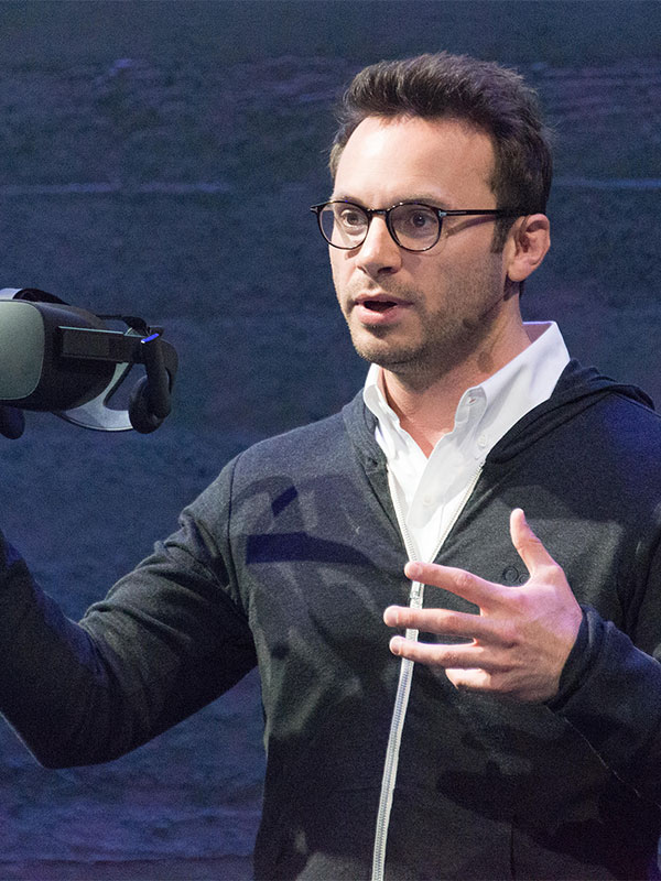 Brendan Iribe, one of the co-founders of Oculus VR, holding an Oculus Rift virtual reality headset