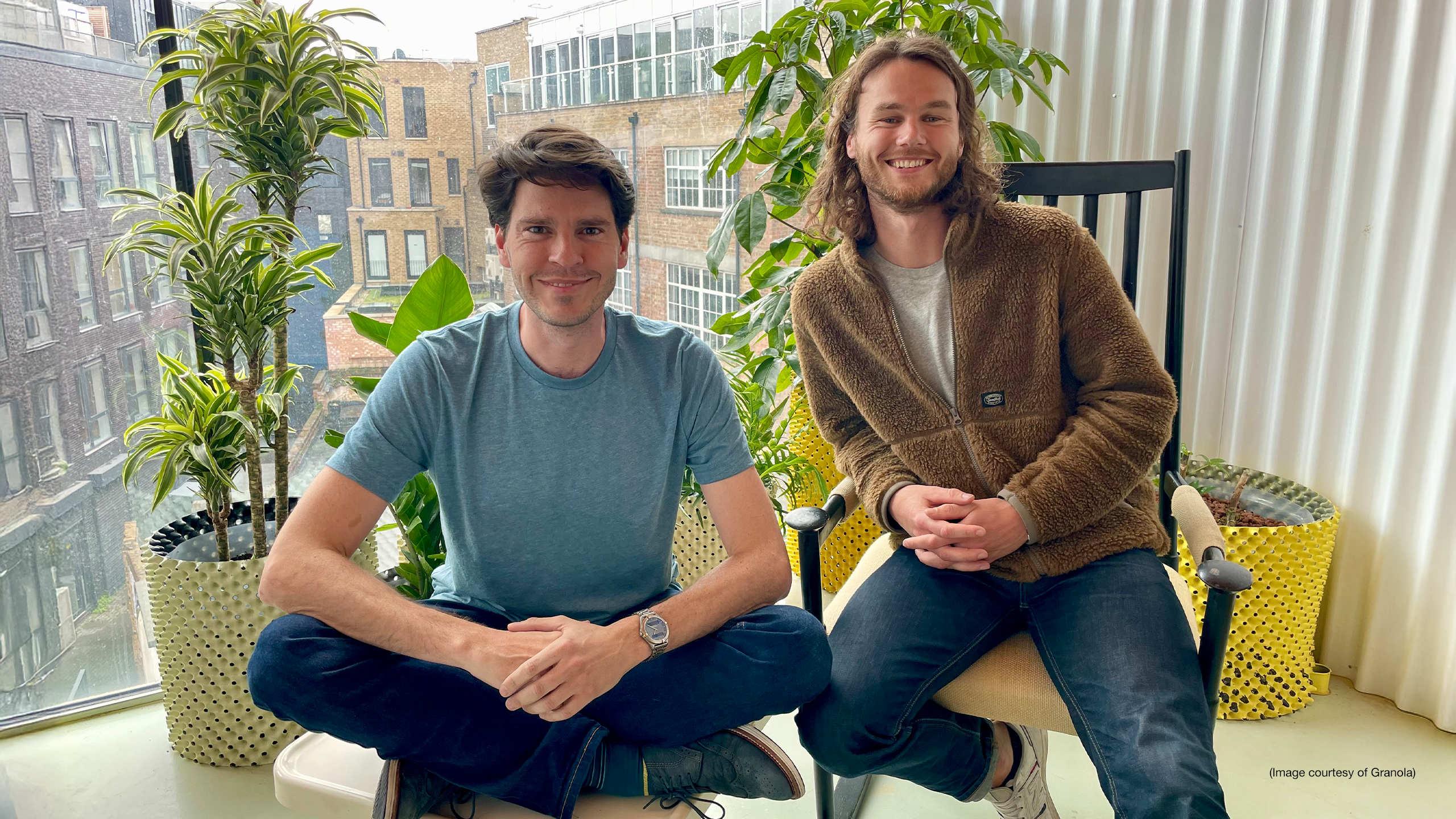 Chris Pedregal and Sam Stephenson, co-founders of Granola, sitting side by side in front of a window of plants