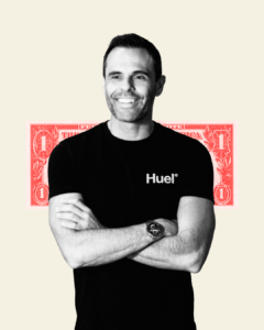 Black and white cut out image with red dollar bill behind Julian Hearn, co-founder of Huel