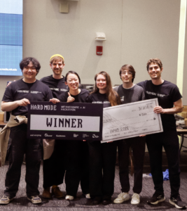Peter He, Ashley Neall, Valdemar Danry, Daniel Kaijzer, Yutong Wu, and Sean Lewis holding up 'winner' sign at MIT Hard Mode
