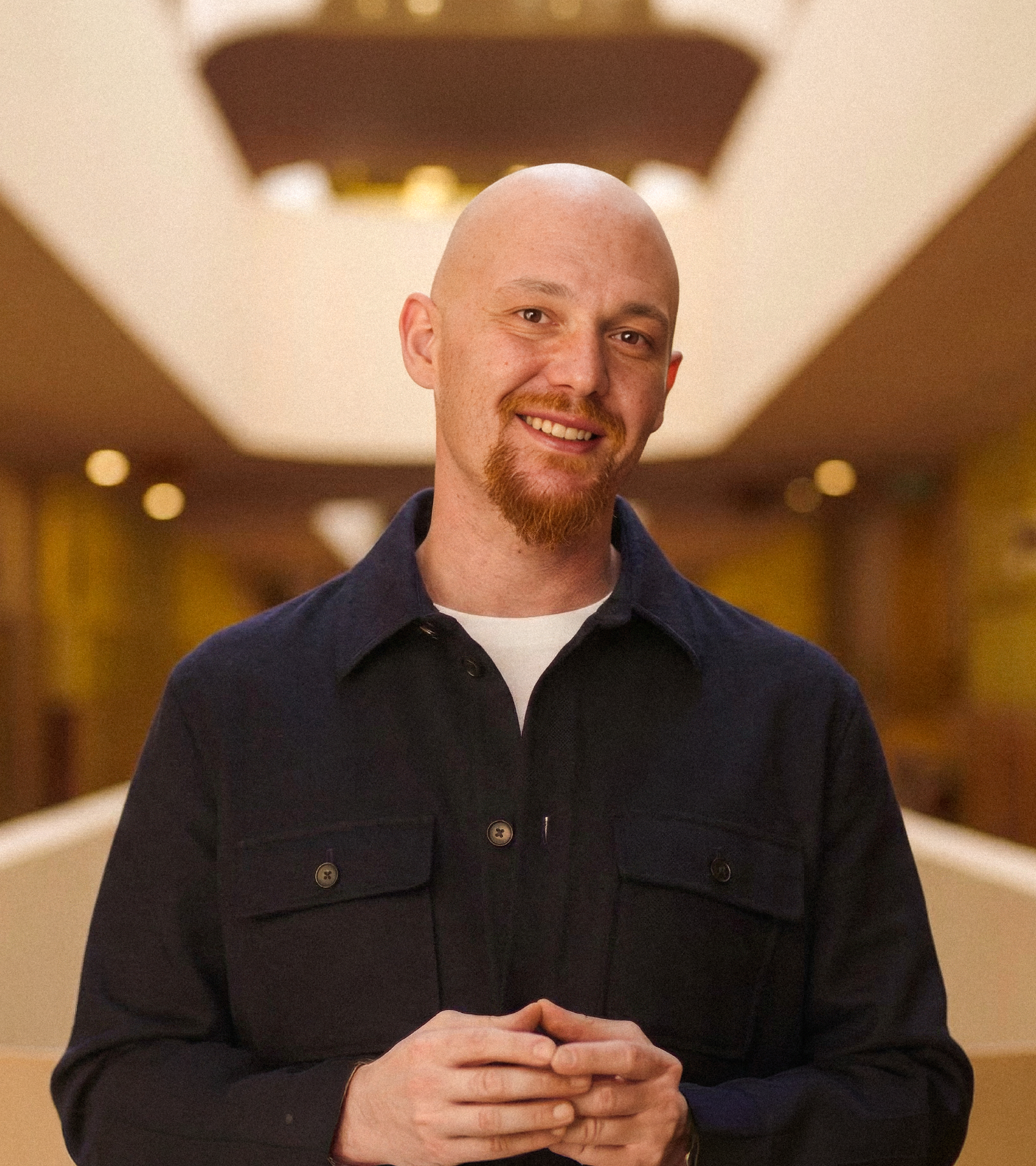 Amjad Masad, co-founder and CEO of vibe coding startup Replit, smiling to the camera in funding announcement