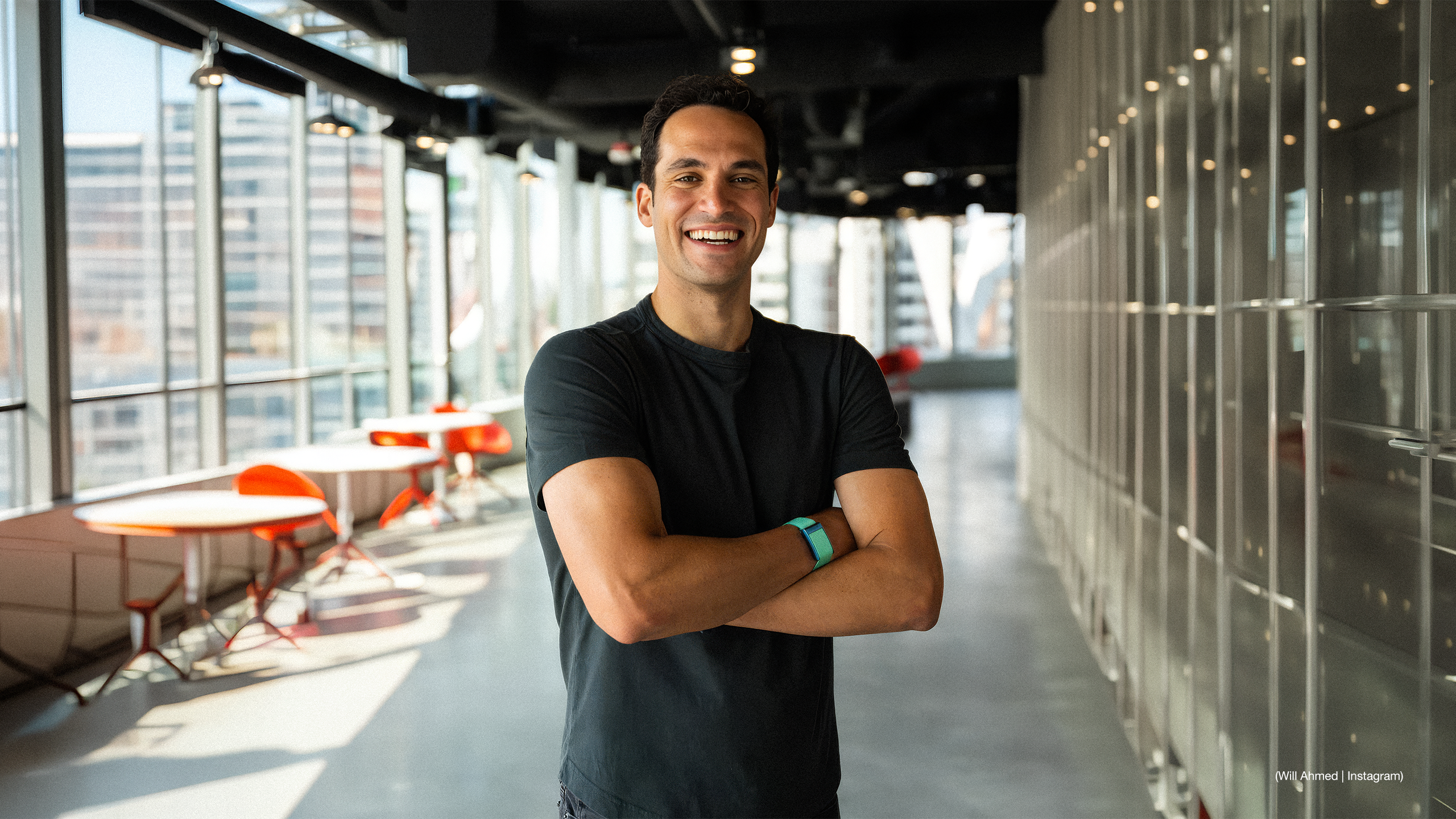 Image of Whoop CEO and founder Will Ahmed smiling with his arms crossed