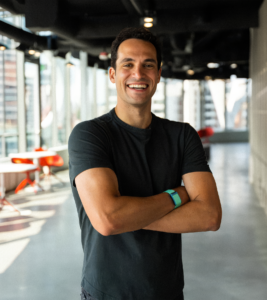 Image of Whoop CEO and founder Will Ahmed smiling with his arms crossed