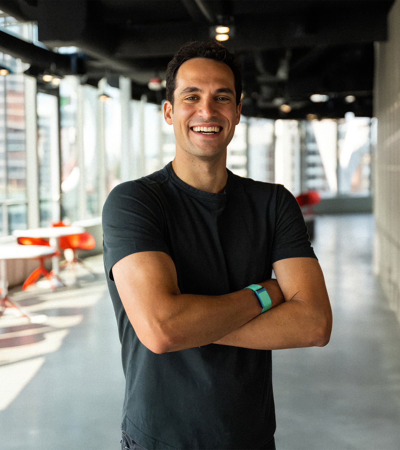 Image of Whoop CEO and founder Will Ahmed smiling with his arms crossed