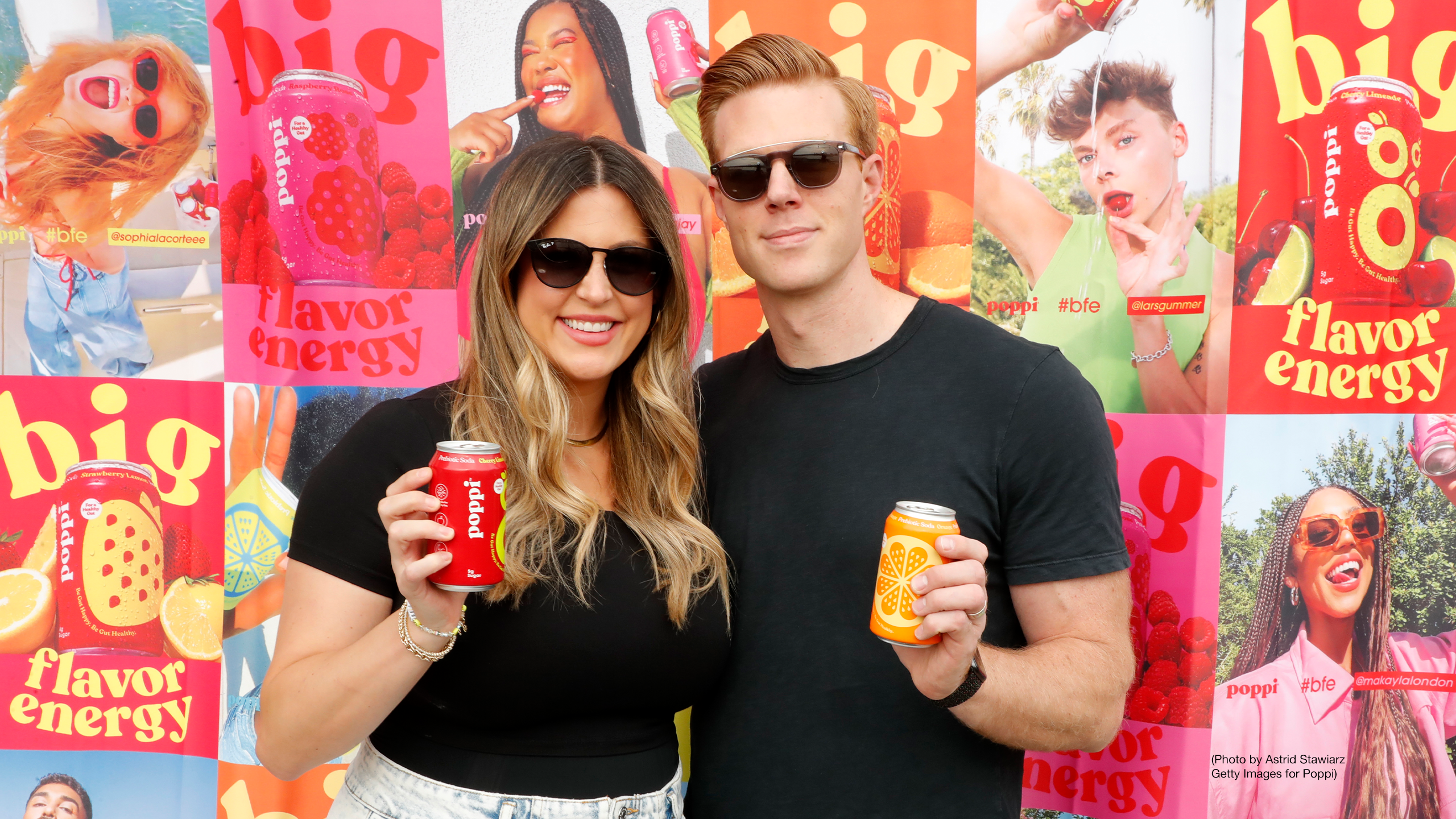 Popular soda brand Poppi's co-founders Allison and Stephen Ellsworth stand side by side at #BFE (Big Flavor Energy) "poppi hour" at Azul On the Rooftop at Hotel Hugo